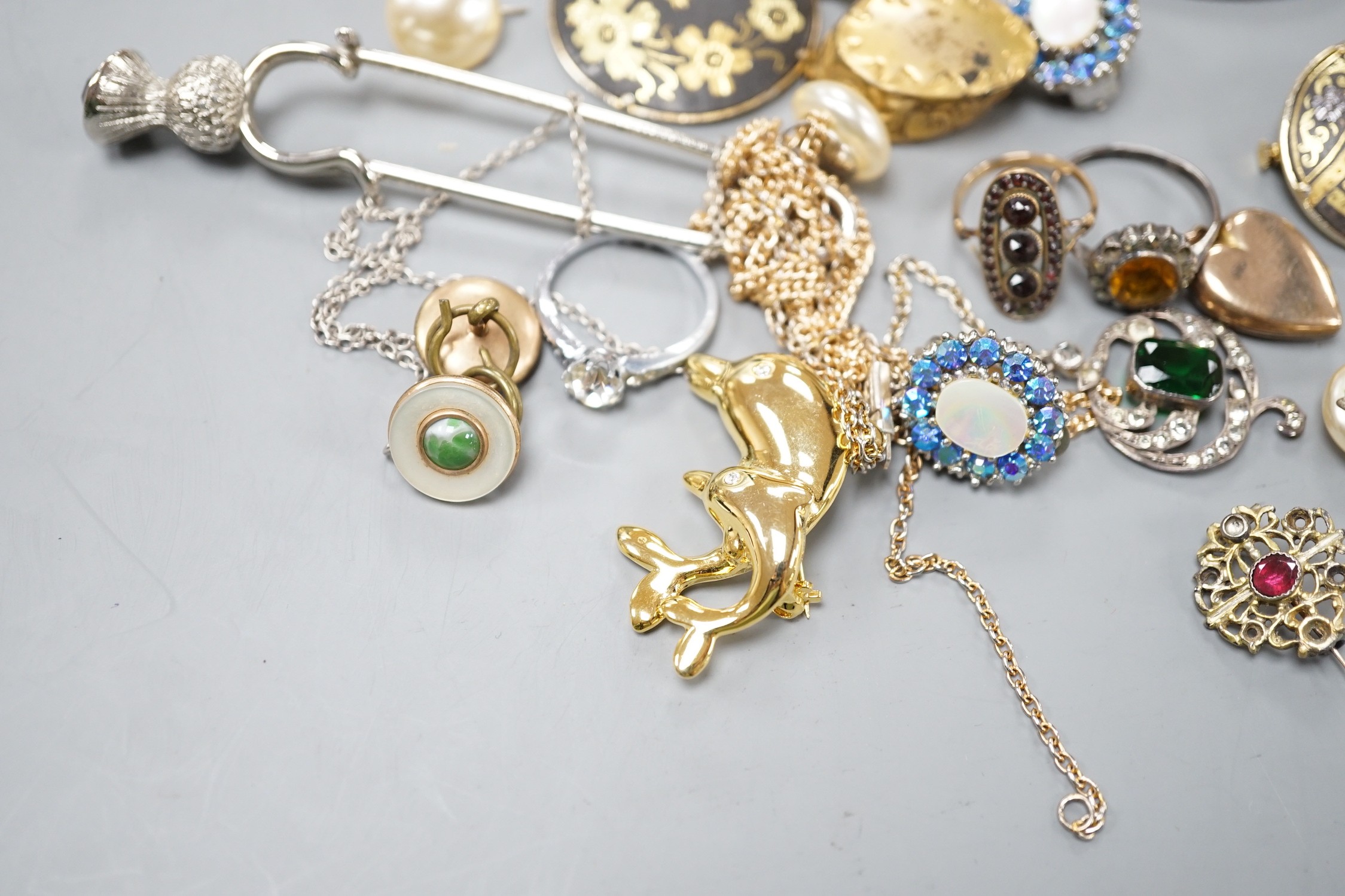 A yellow metal and turquoise cluster set dress ring(stone missing), a similar seed pearl set heart shaped locket and a group of assorted costume jewellery.